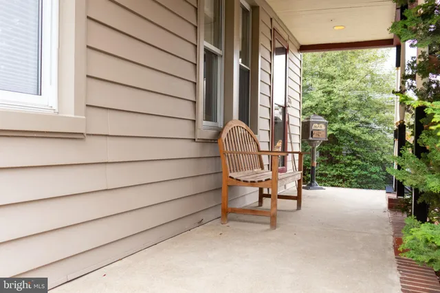 a view of a chair and table in backyard of the house