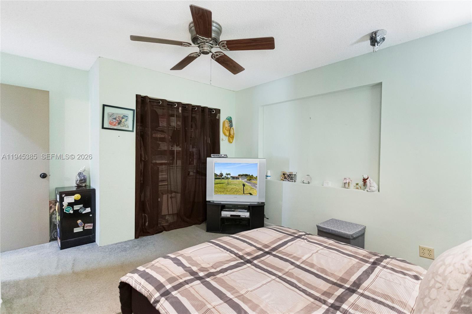 4841 Southwest 201st Terrace Southwest Ranches, FL 33332 - Photo 11 of 16 a bedroom with a bed and a chandelier