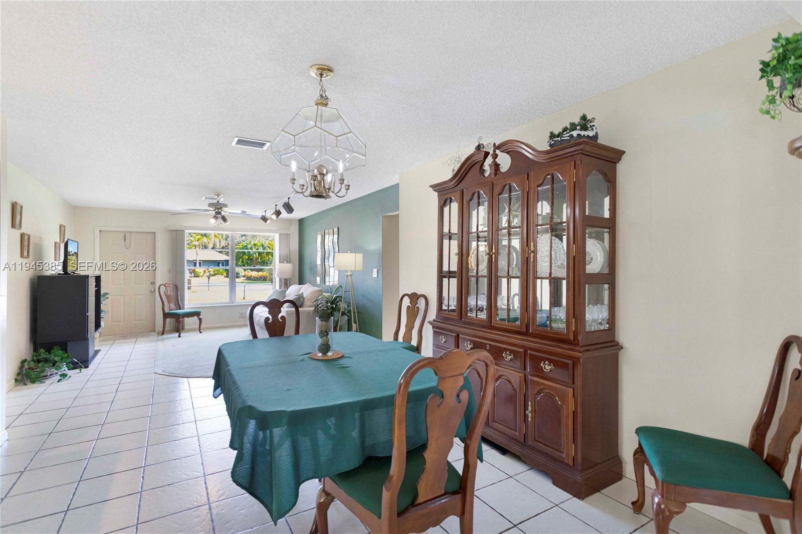 4841 Southwest 201st Terrace Southwest Ranches, FL 33332 - Photo 8 of 16 a view of a dining room with furniture and window