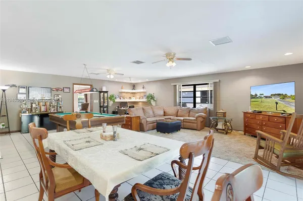 a living room with furniture gym equipment and a view of bedroom