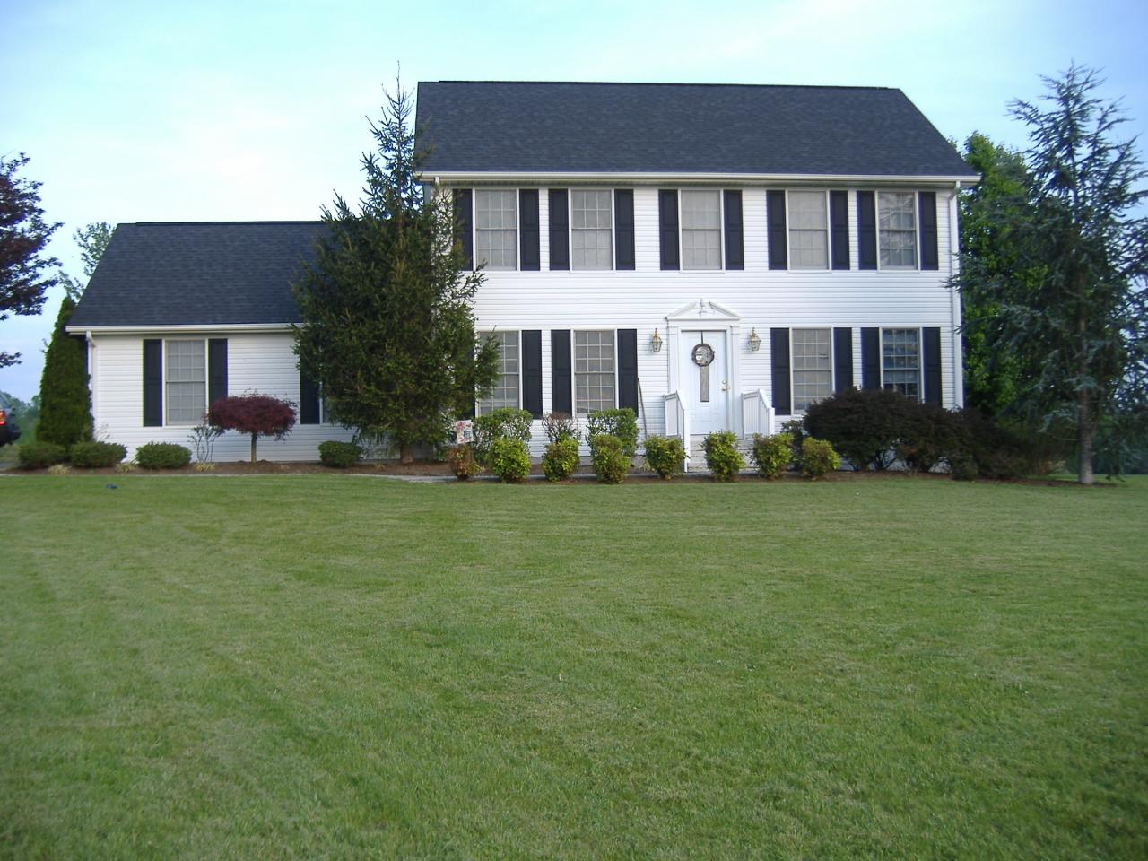 1420 Mill Iron Road Goodview, VA 24095 - Photo 1 of 26 a front view of a house with garden