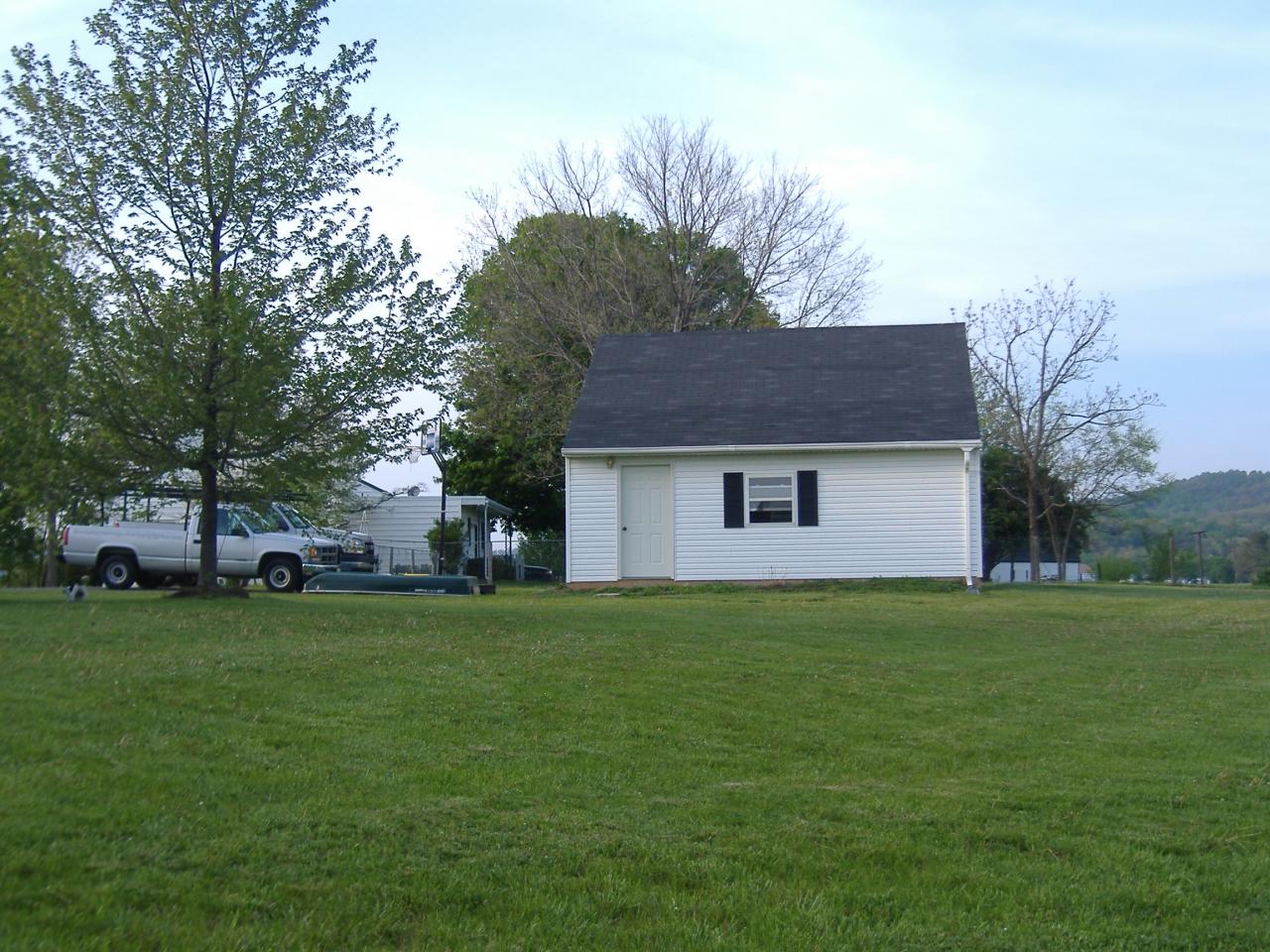 1420 Mill Iron Road Goodview, VA 24095 - Photo 11 of 26 a front view of a house with a garden