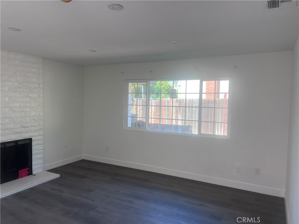 195 Masters Avenue Riverside, CA 92507 - Photo 1 of 4 an empty room with wooden floor and a window