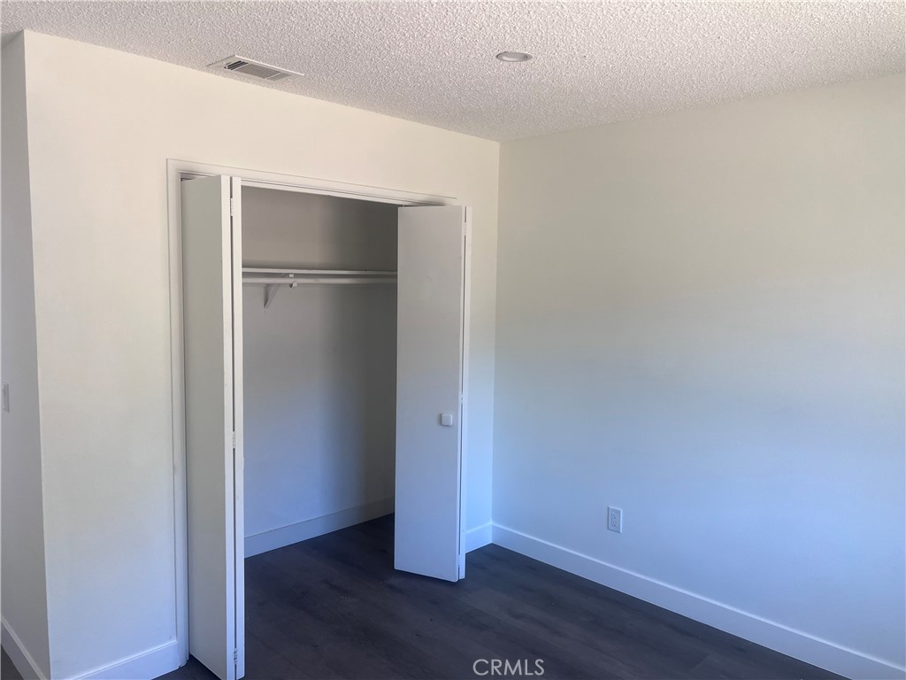 195 Masters Avenue Riverside, CA 92507 - Photo 2 of 4 a view of an empty room with wooden floor