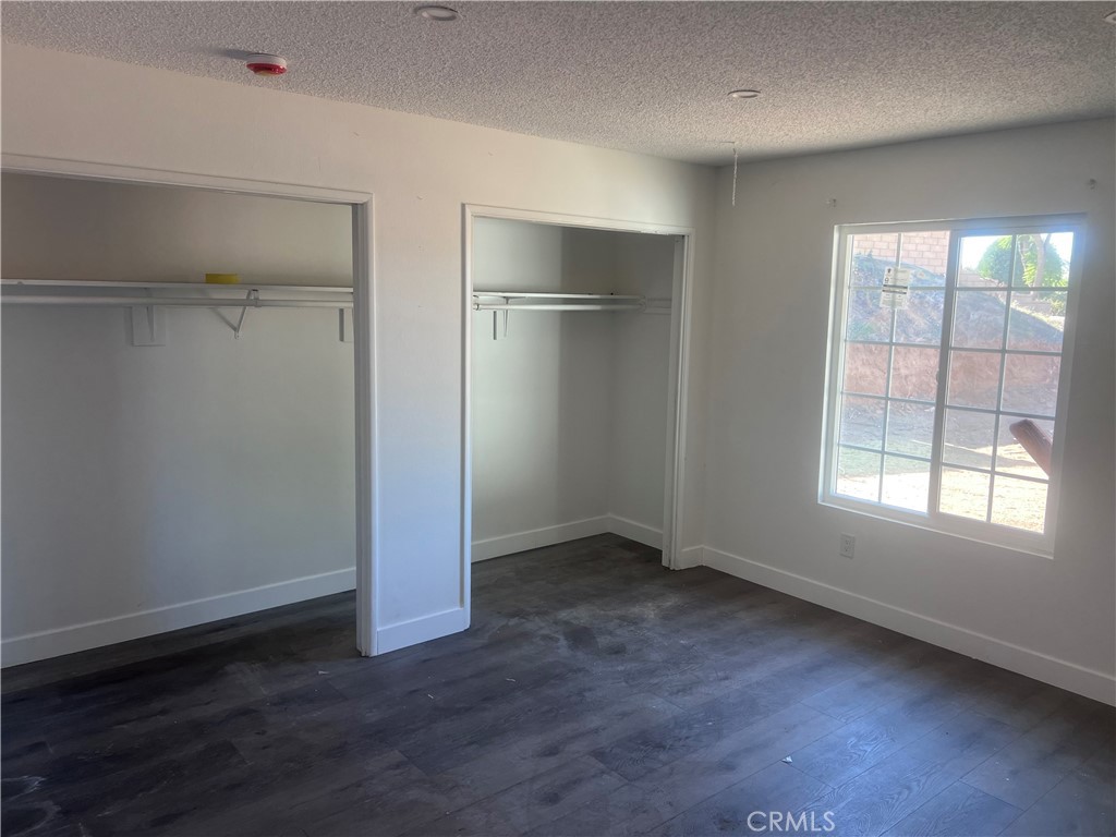 195 Masters Avenue Riverside, CA 92507 - Photo 3 of 4 a view of an empty room with wooden floor and a window