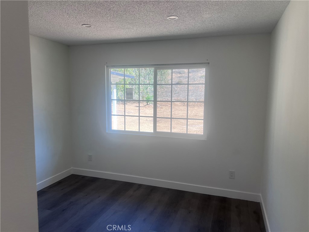 195 Masters Avenue Riverside, CA 92507 - Photo 4 of 4 an empty room with wooden floor and windows