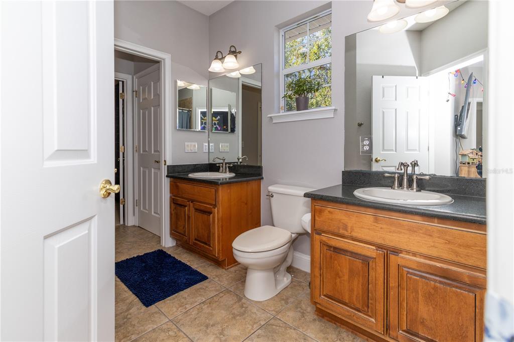 3305 Schoolhouse Road St. Cloud, FL 34773 - Photo 46 of 83 a bathroom with a toilet sink and mirror