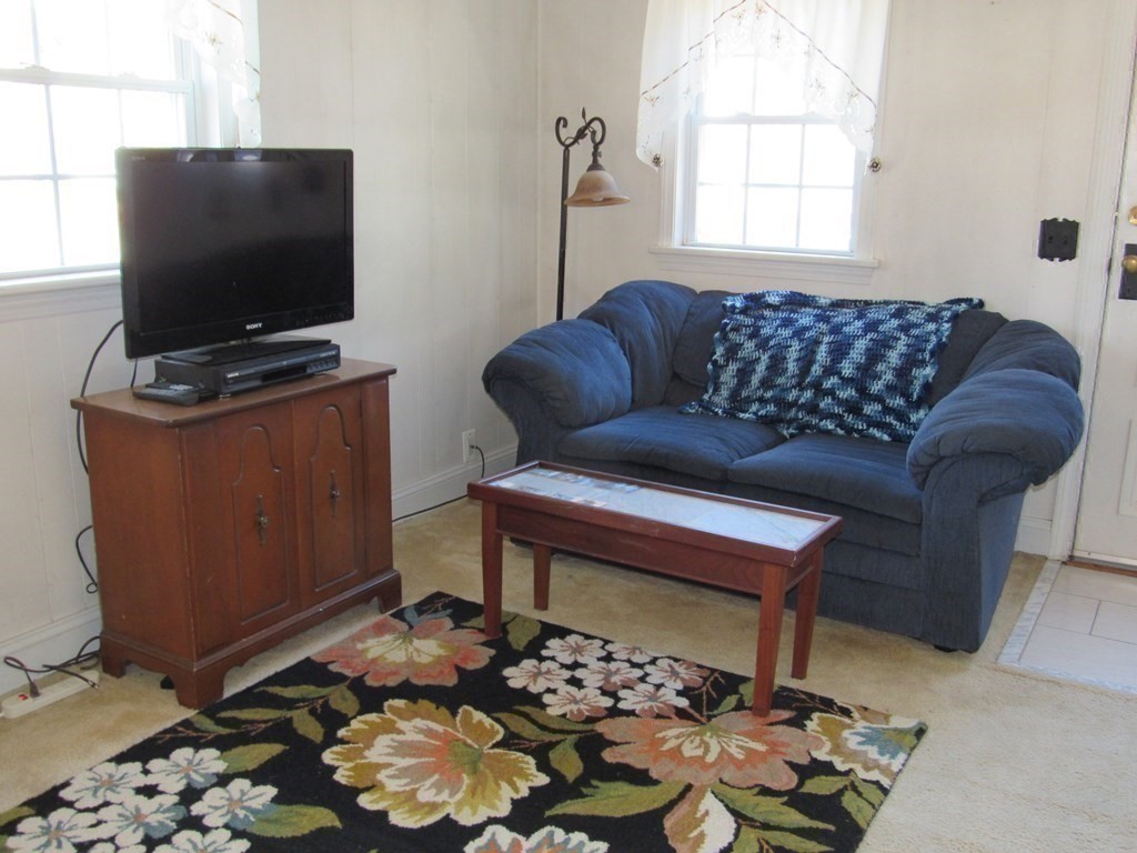 92 Hathaway Street Wareham, MA 02571 - Photo 11 of 29 a living room with furniture and a flat screen tv