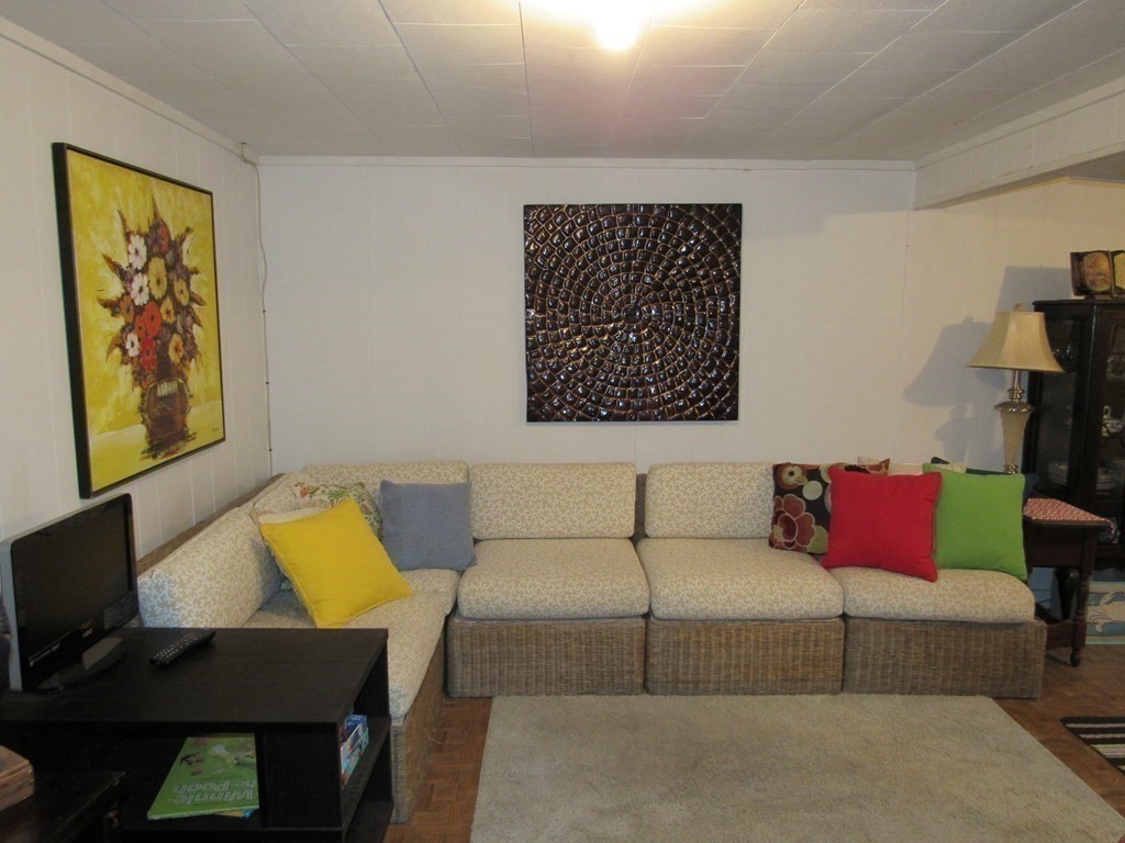 92 Hathaway Street Wareham, MA 02571 - Photo 22 of 29 a living room with a couch and a table