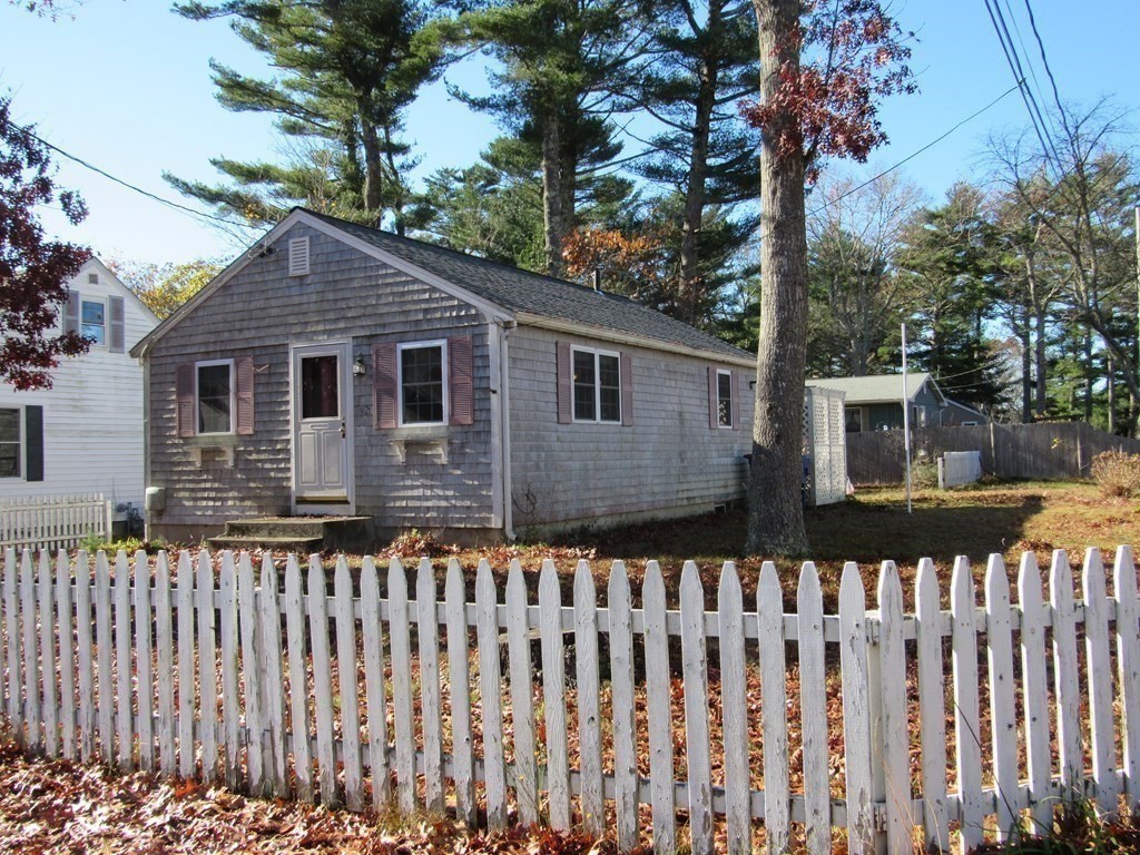 92 Hathaway Street Wareham, MA 02571 - Photo 3 of 29 a front view of house with yard and trees around