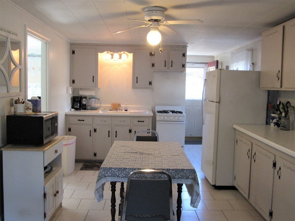 92 Hathaway Street Wareham, MA 02571 - Photo 4 of 29 a kitchen with kitchen island a sink stove and refrigerator