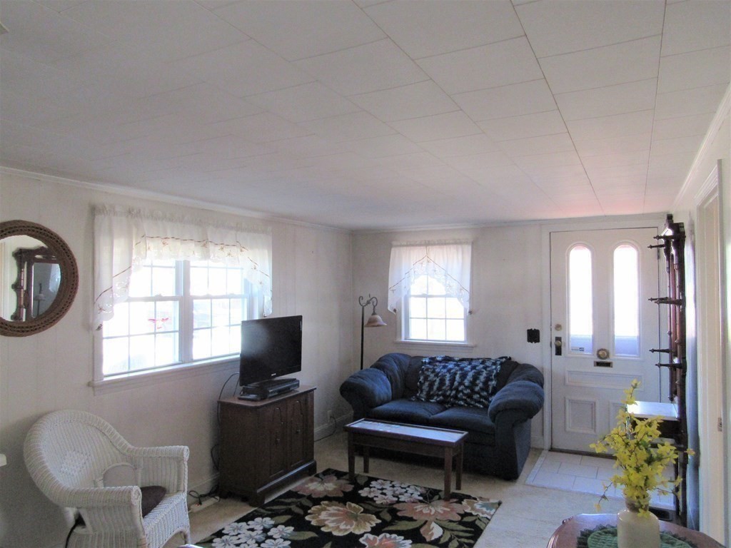 92 Hathaway Street Wareham, MA 02571 - Photo 10 of 29 a living room with furniture and a flat screen tv