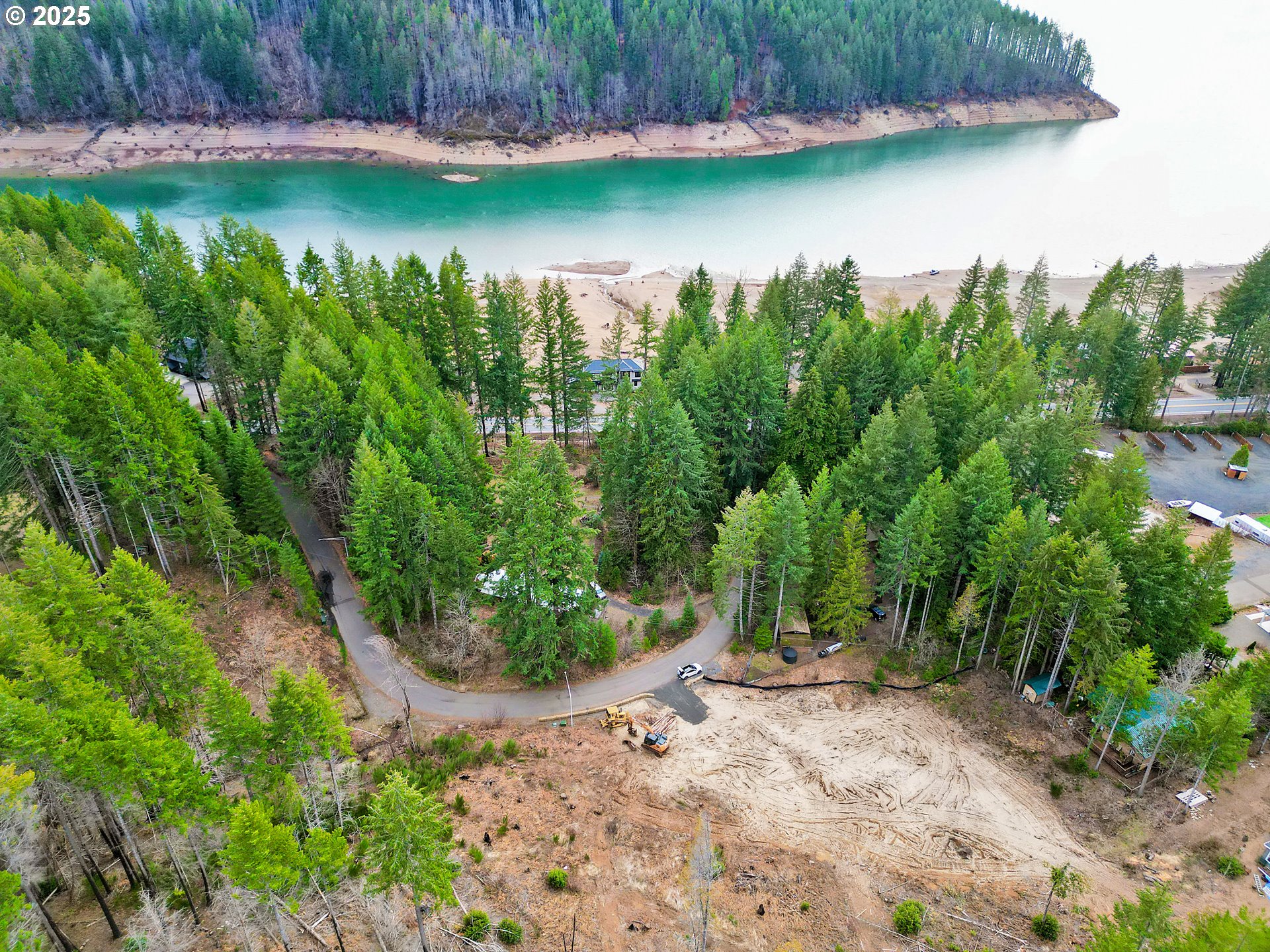 110 Guy Moore Road, Unit 2 Detroit, OR 97342 - Photo 2 of 12 a view of a lake with a yard and trees