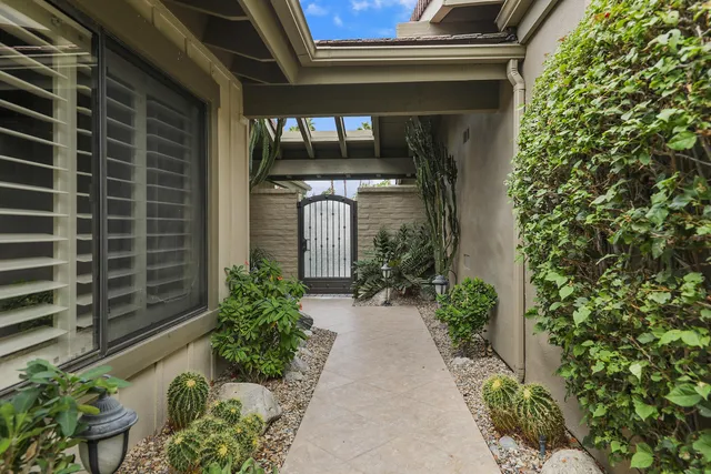 a front view of a house with potted plants
