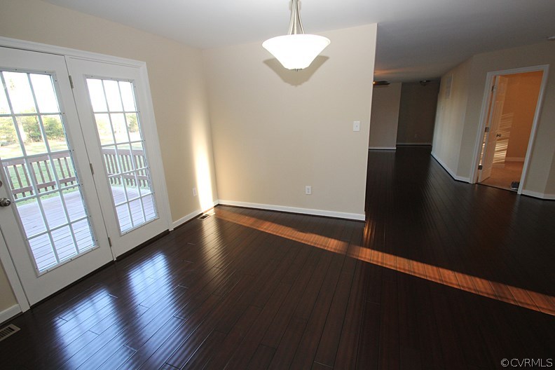 12401 Lewis Road Chester, VA 23831 - Photo 8 of 28 a view of an empty room with wooden floor and a window