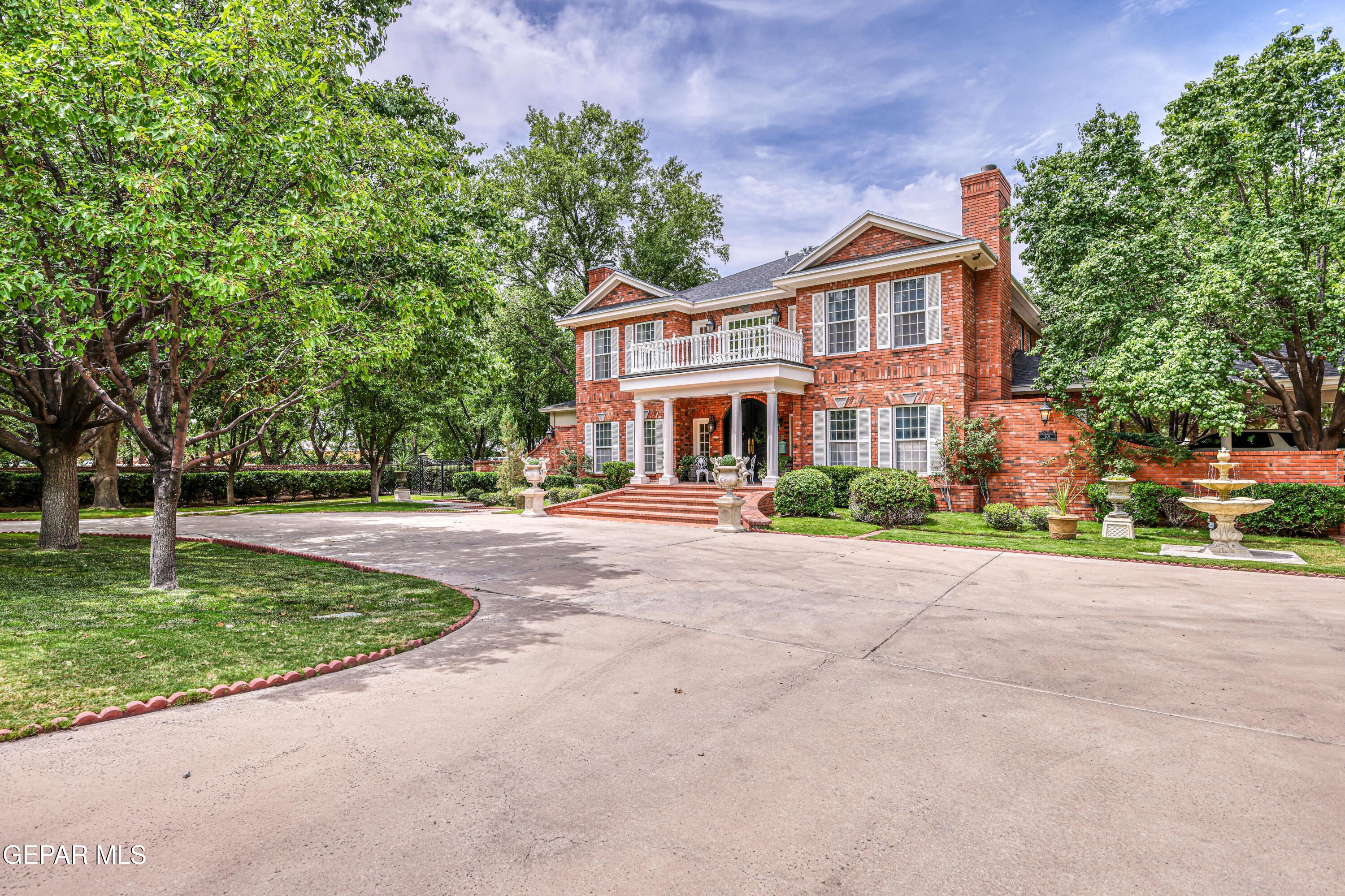 501 Country Club Road El Paso, TX 79932 - Photo 4 of 88 a front view of a house with a garden and trees