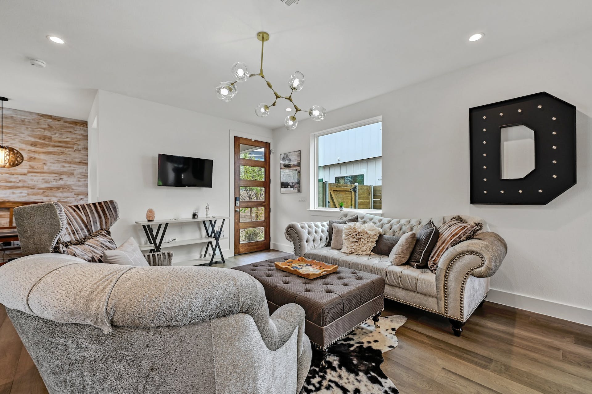 201 Tillery Square, Unit 2 Austin, TX 78702 - Photo 6 of 20 Living area featuring wood finished floors, premium lighting, and an accent wall