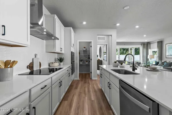 a large kitchen with kitchen island a sink table and chairs