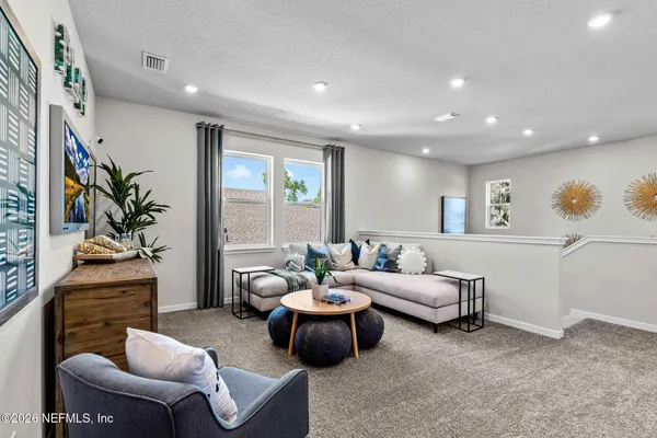 a spacious bedroom with a bed and a couch
