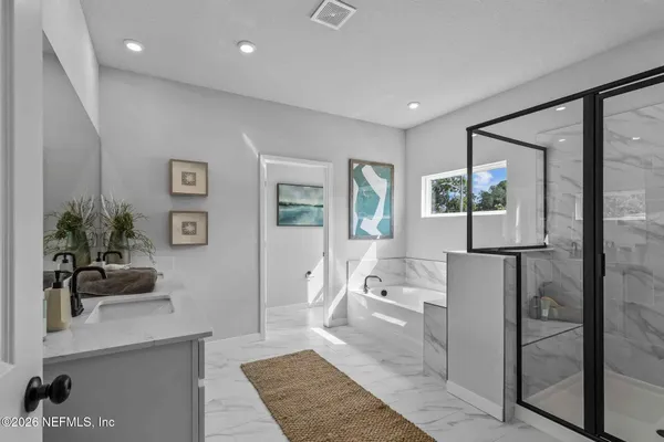 a bathroom with double vanity sink and mirror