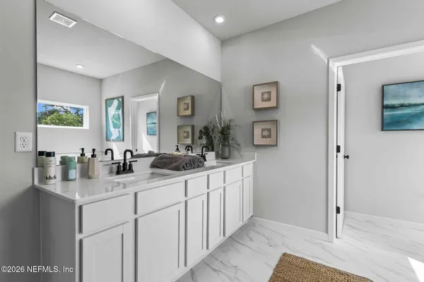 a bathroom with a granite countertop sink mirror and shower