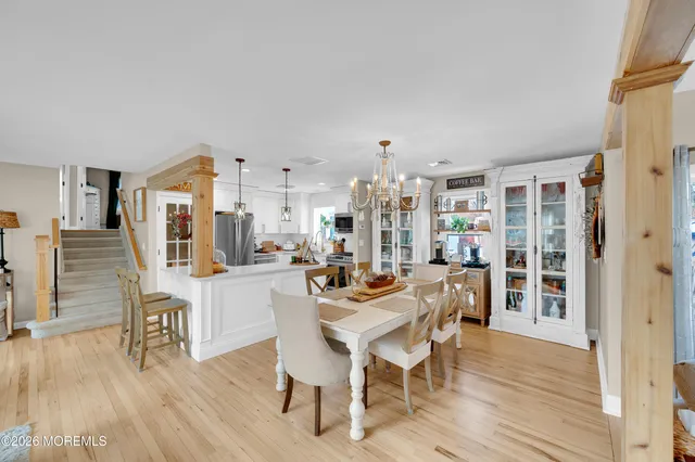 a dining room with furniture and wooden floor