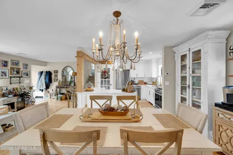 a living room with lots of furniture and kitchen view