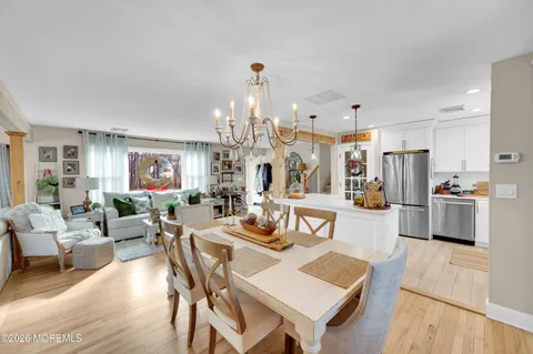 a living room with lots of furniture and kitchen view
