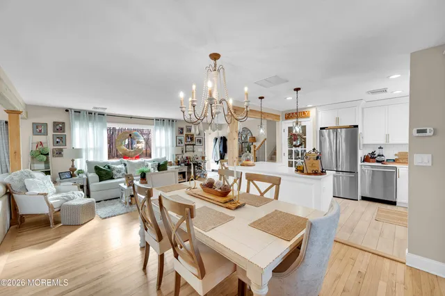 a living room with lots of furniture and kitchen view