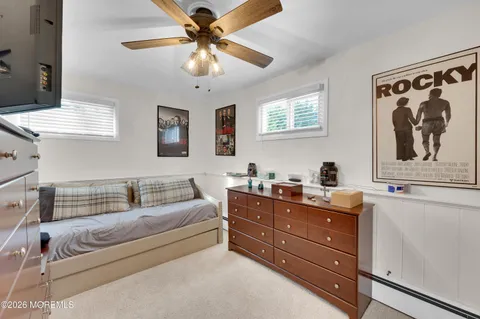 a living room with furniture and a ceiling fan