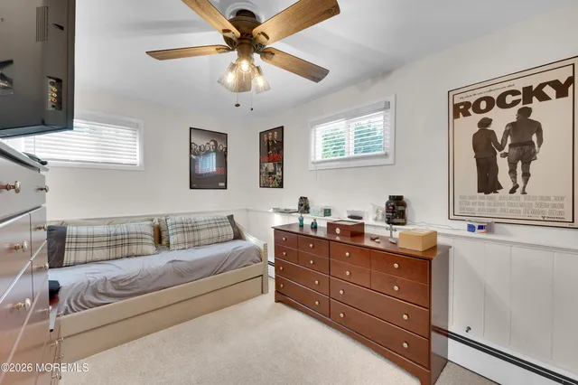 a living room with furniture and a ceiling fan