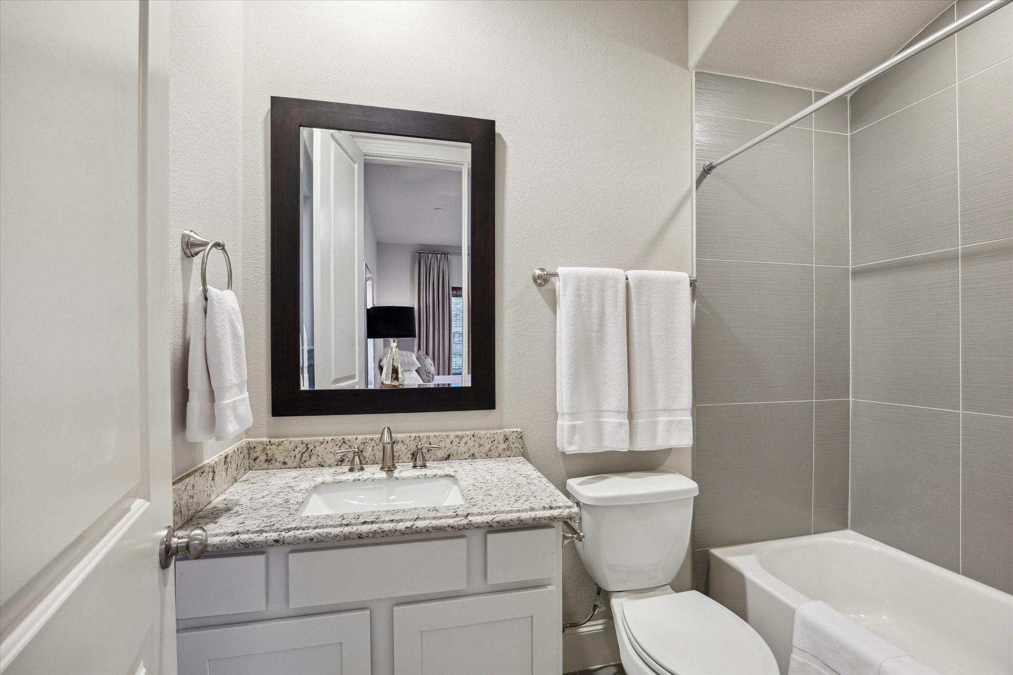 9634 Kings Cross Station Houston, TX 77045 - Photo 17 of 24 a bathroom with a granite countertop sink toilet and mirror