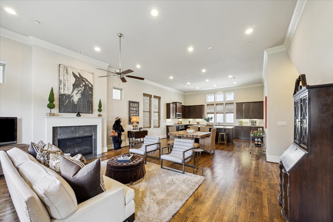 9634 Kings Cross Station Houston, TX 77045 - Photo 3 of 24 LIVING ROOM – Living room includes wood floors and a gas log fireplace with limestone surround.