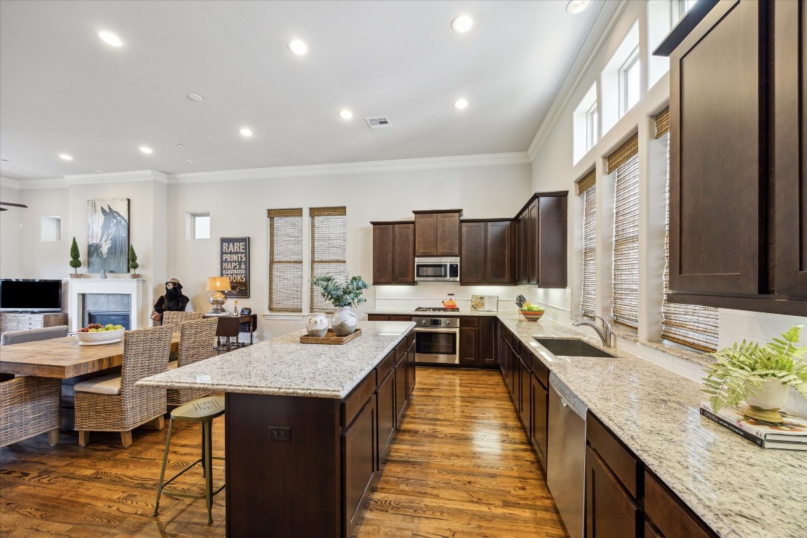 9634 Kings Cross Station Houston, TX 77045 - Photo 7 of 24 KITCHEN II – Another view of the kitchen with island seating and ample storage.