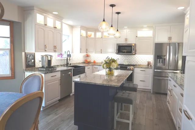 a kitchen with stainless steel appliances granite countertop a sink stove and refrigerator