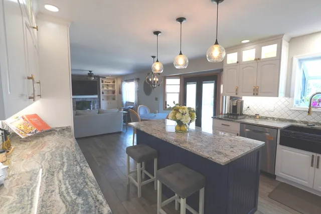 a dining room with furniture a chandelier and wooden floor