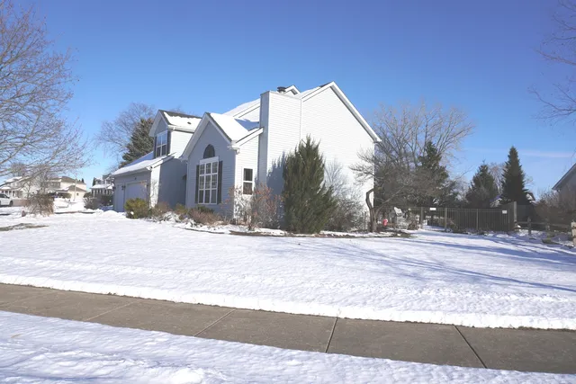 a view of a house with a snow in the background
