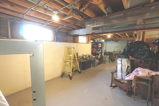 a front view of a house with a yard covered with snow and trees