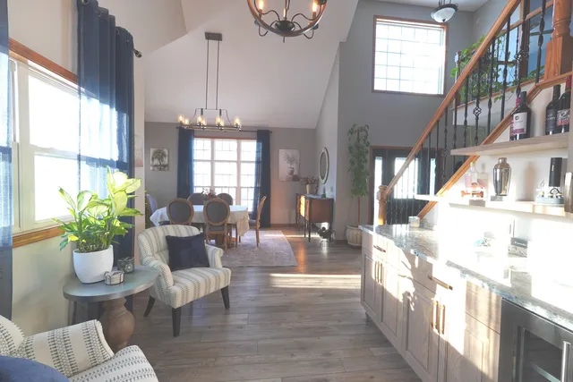 a living room with furniture and a chandelier