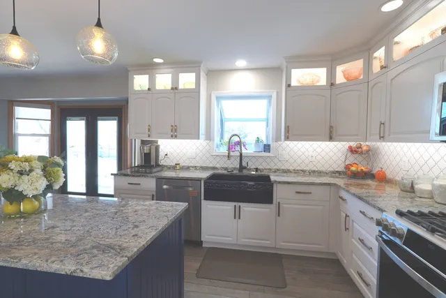 a kitchen with stainless steel appliances granite countertop a sink stove and refrigerator