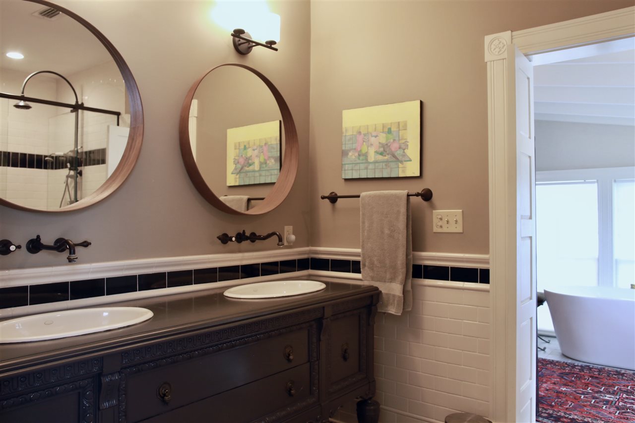 15 Bridge Street St. Augustine, FL 32084 - Photo 23 of 49 a bathroom with a double vanity sink and a mirror