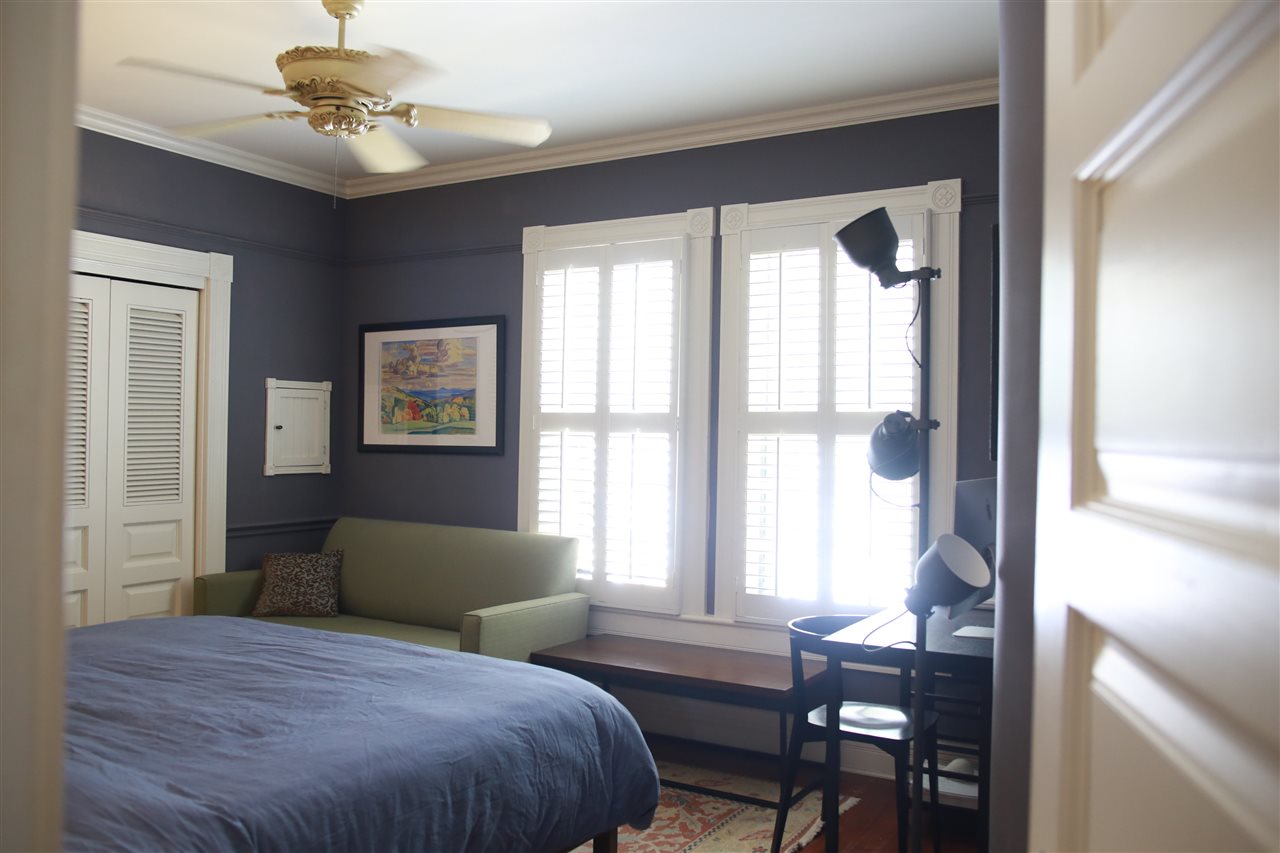 15 Bridge Street St. Augustine, FL 32084 - Photo 29 of 49 a bedroom with a large bed and a chandelier