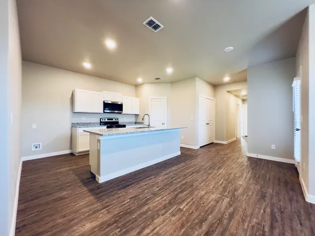a view of kitchen with sink microwave and refrigerator
