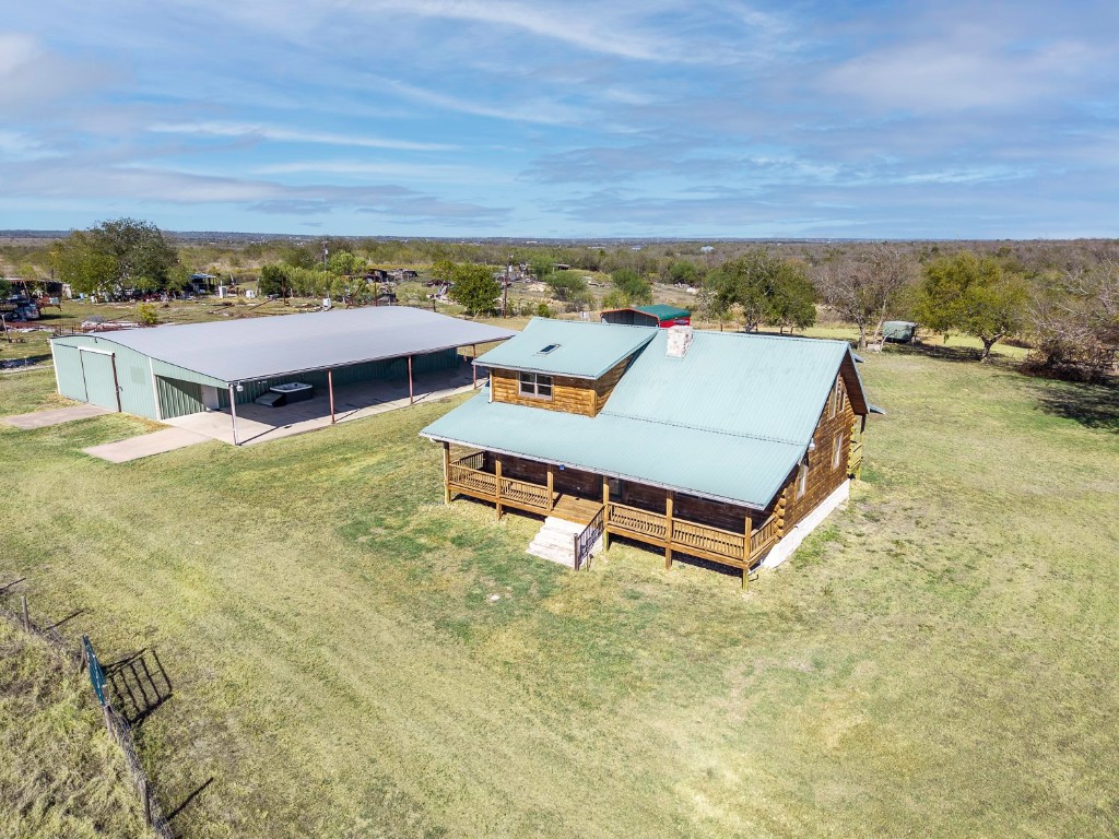 an aerial view of residential house with pool and ocean view