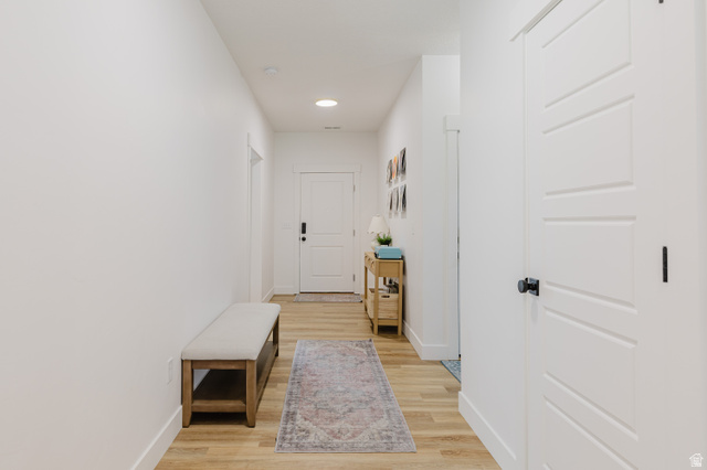 287 East 1000 North Logan, UT 84321 - Photo 33 of 41 Light wood-finish flooring extends through this hallway featuring recessed lighting and white walls