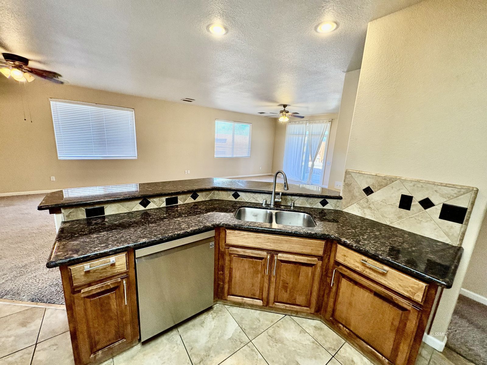 416 Olive Avenue Ridgecrest, CA 93555 - Photo 21 of 35 a kitchen with granite countertop stainless steel appliances a sink stove top oven and cabinets
