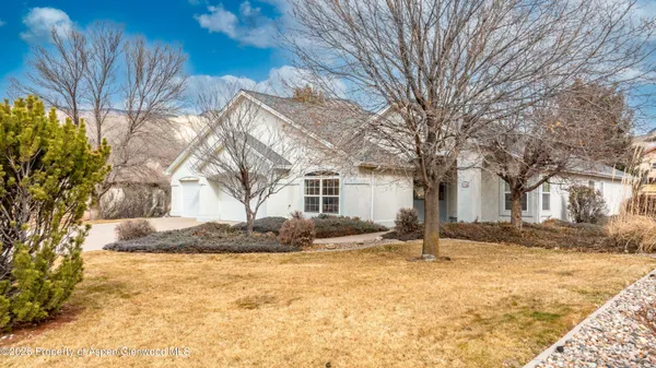 a front view of a house with a yard covered in snow