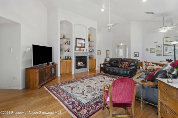 a living room with furniture fireplace and flat screen tv