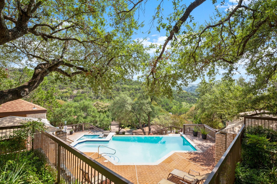 4906 Bob Cat Run Austin, TX 78731 - Photo 1 of 37 View of community pool with a patio area and view of scattered trees