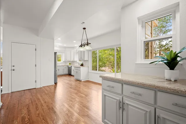 a view of a kitchen with a sink cabinets and wooden floor